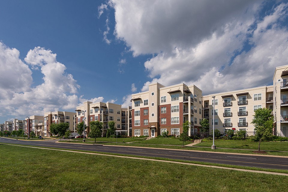 a row of apartment buildings on the side of a road