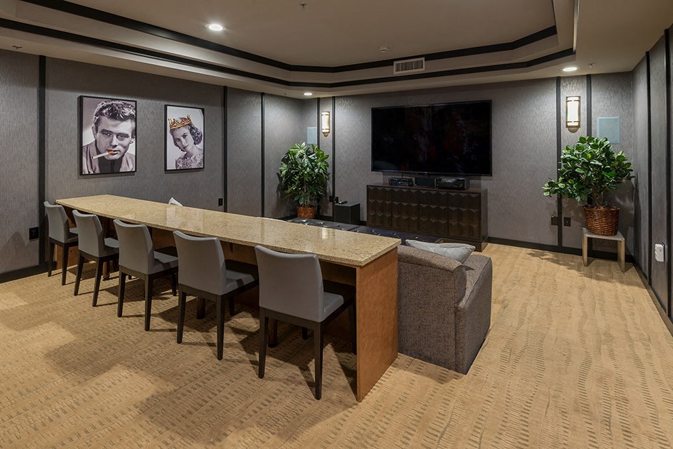 a conference room with a table and chairs and a television