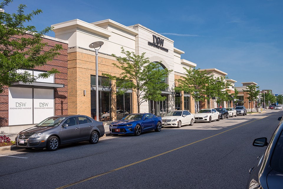a city street with cars parked in front of a building