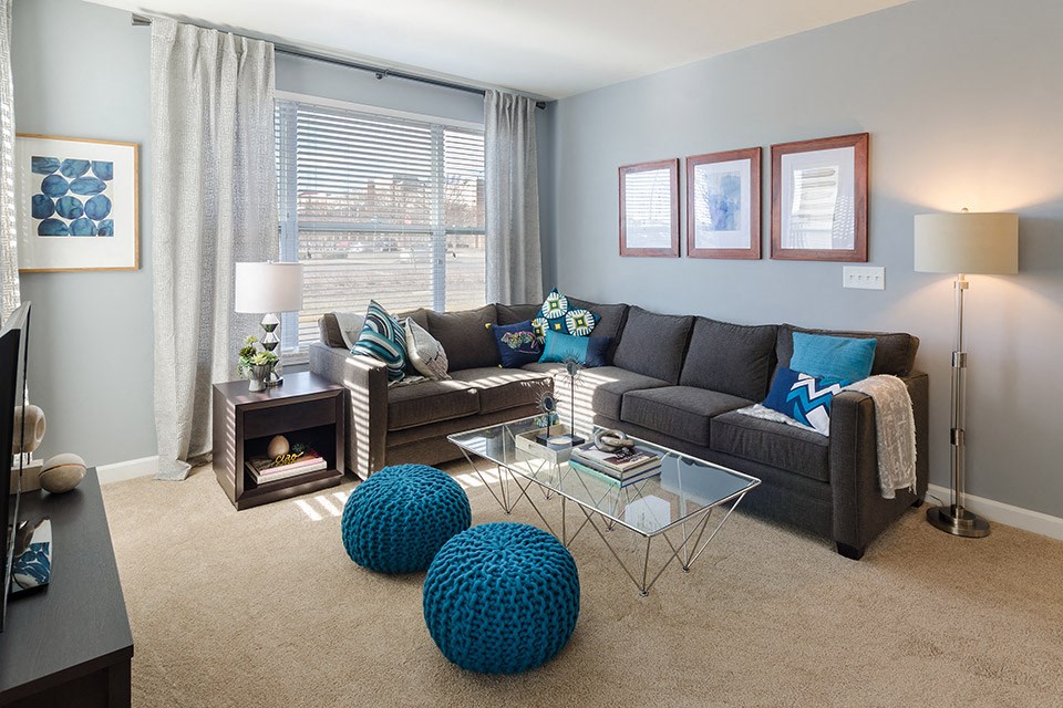 a living room with a couch and a glass coffee table