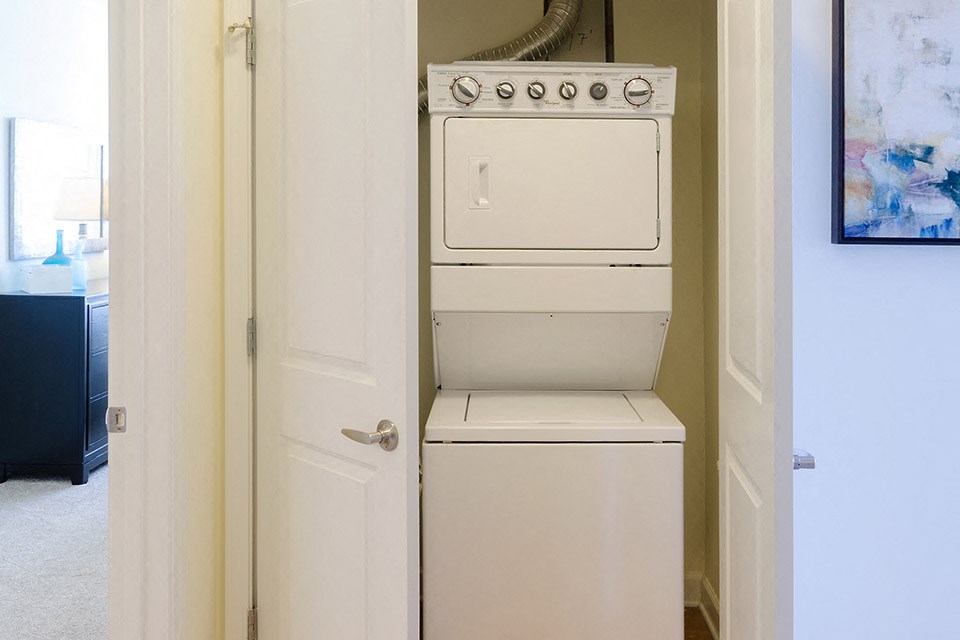 a washer and dryer in a small closet in a home