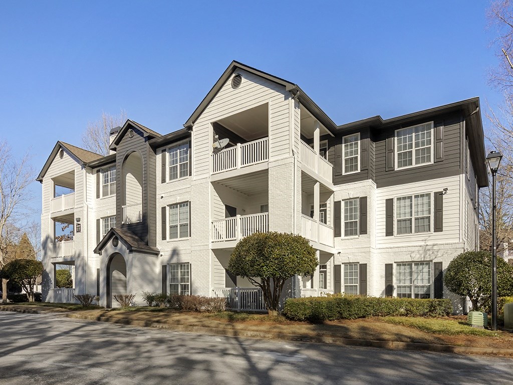 a large apartment building with a blue sky in the background