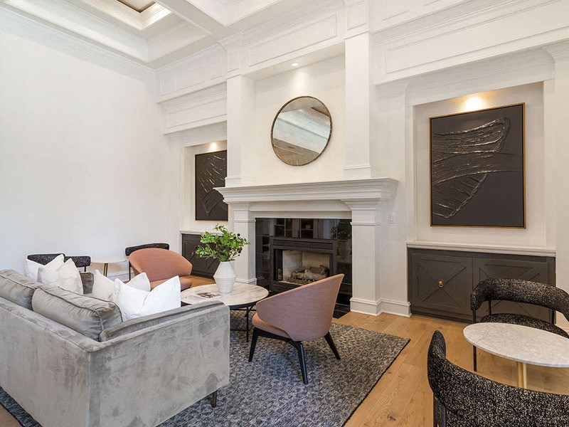 a living room with white walls and coffered ceilings