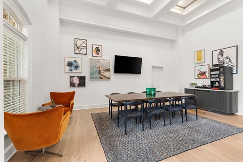 A living room with a brown chair and a black table.