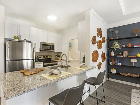 a kitchen with stainless steel appliances and granite counter tops