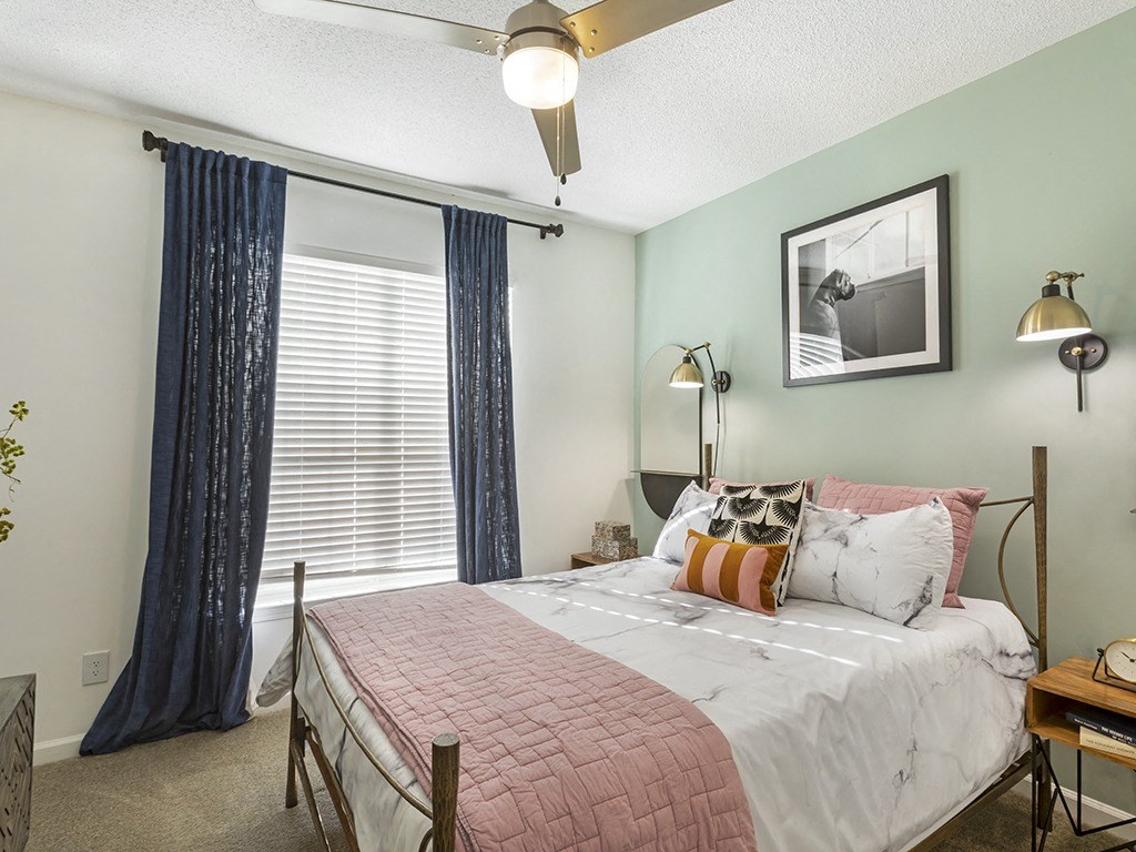 a bedroom with a bed and a window