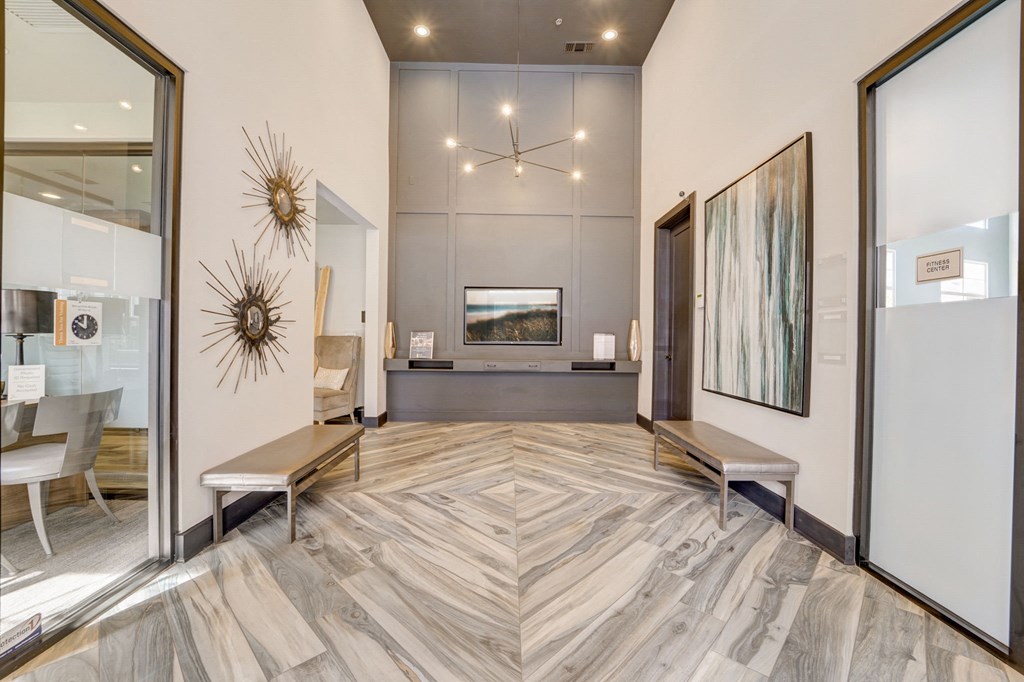 a living room with a hard wood floor and a large mirror