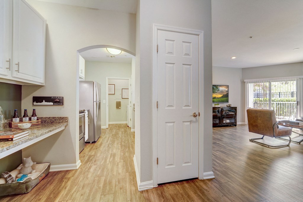 a kitchen and living room with a white door