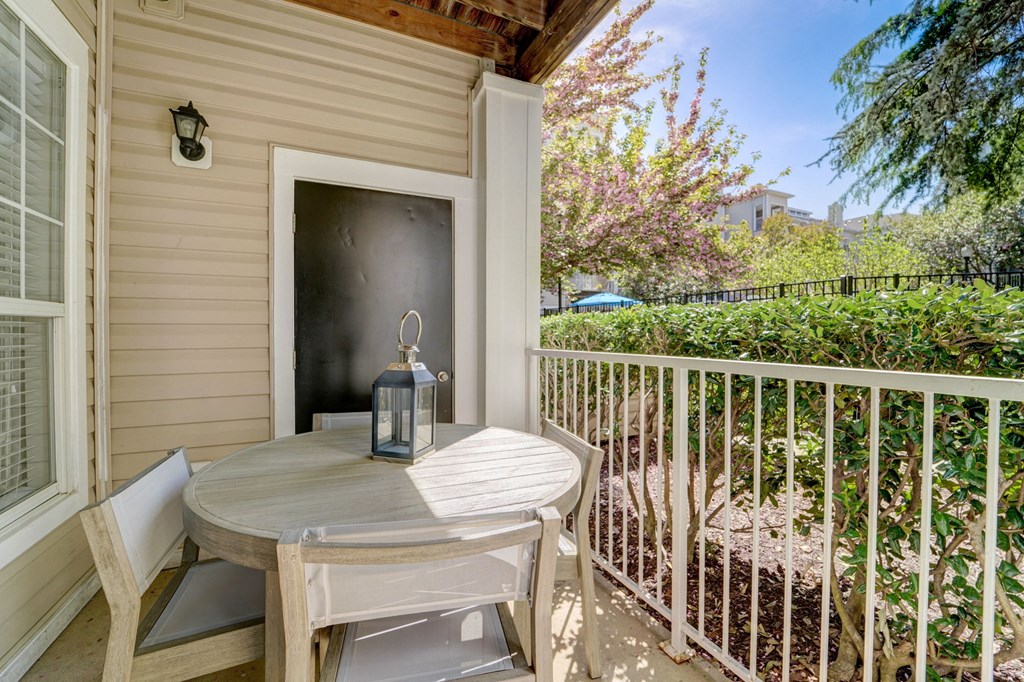 a patio with a table and chairs on a balcony