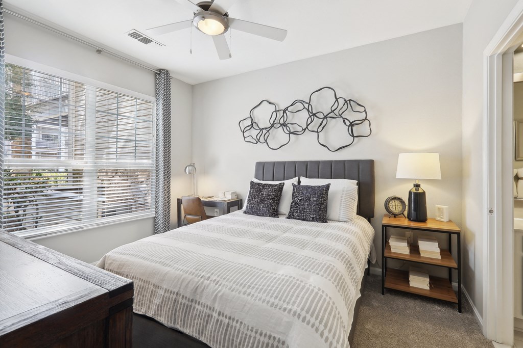 a bedroom with a large bed and a ceiling fan