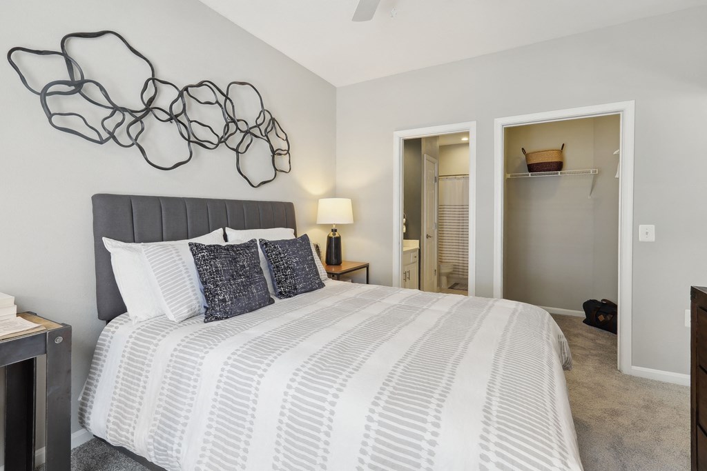 a bedroom with a large bed and a closet