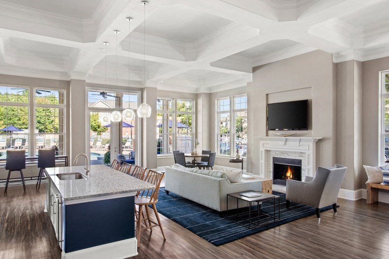 a living room with a fireplace and a kitchen