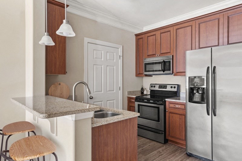 a kitchen with wooden cabinets and stainless steel appliances