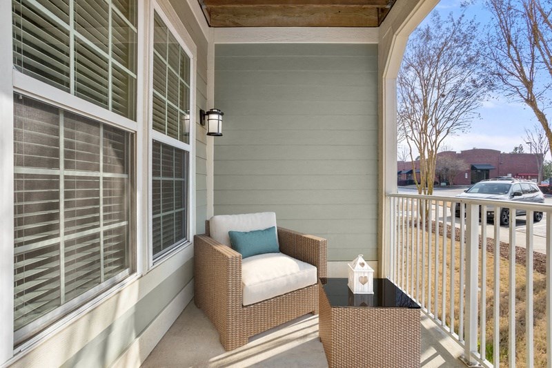 a porch with two chairs and a table