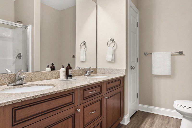 a bathroom with two sinks and a toilet