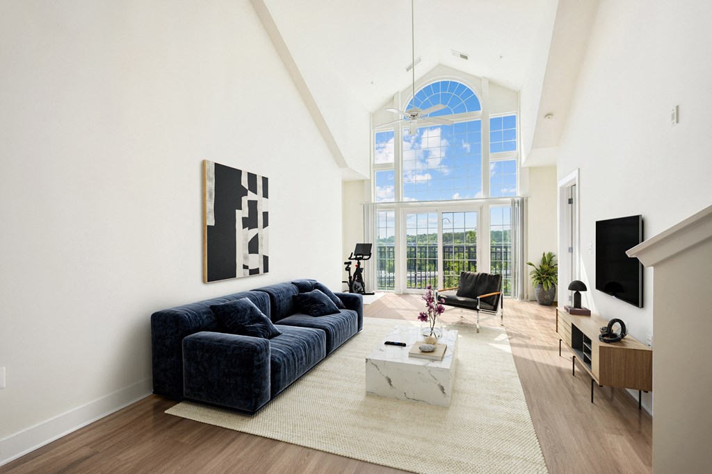 a living room with a blue couch and a large window