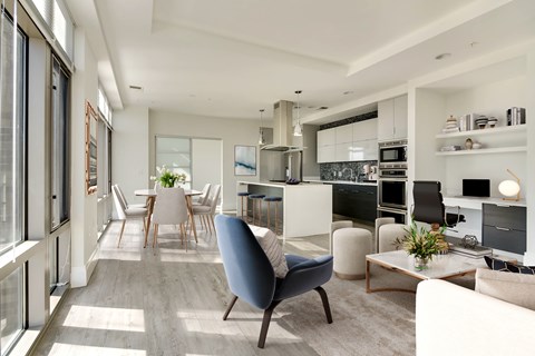 A modern living room with a blue chair in the foreground.