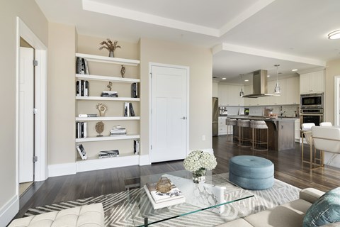 A modern living room with a glass coffee table and a white sofa.