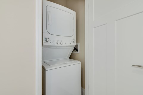 A white dishwasher is open and placed in a kitchen.