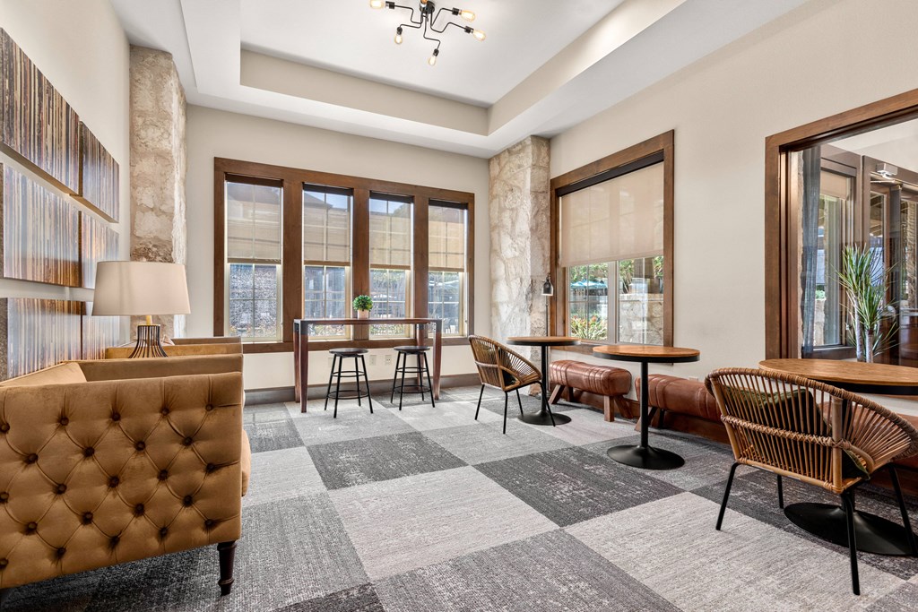 a lobby with a seating area and a table with chairs