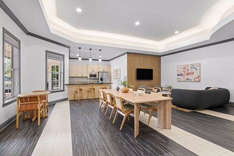 A modern dining room with a wooden table and chairs.