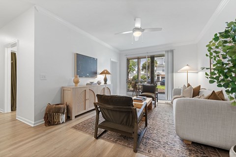 A living room with a brown chair and a grey couch.