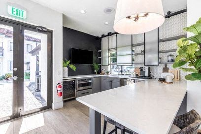 a kitchen with a white counter top and a door