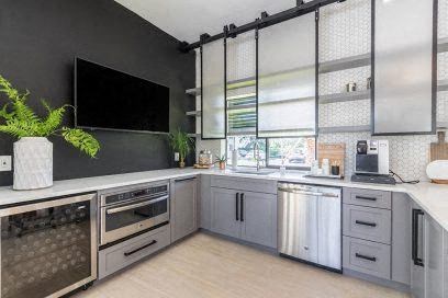 A modern kitchen with a large island and stainless steel appliances.