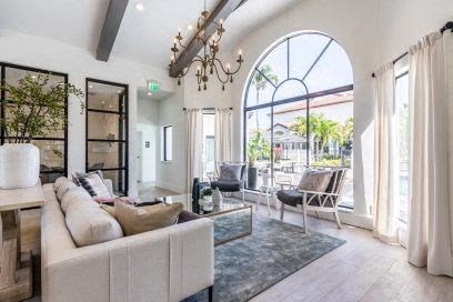 a living room with a white couch and a large window