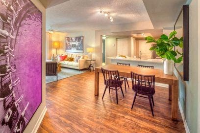 a living room and dining room with a table and chairs