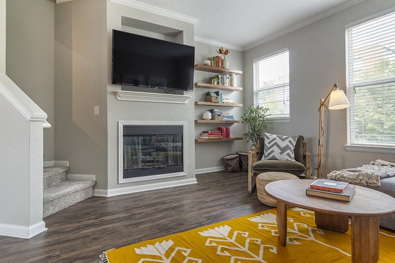 a living room with a fireplace and a television