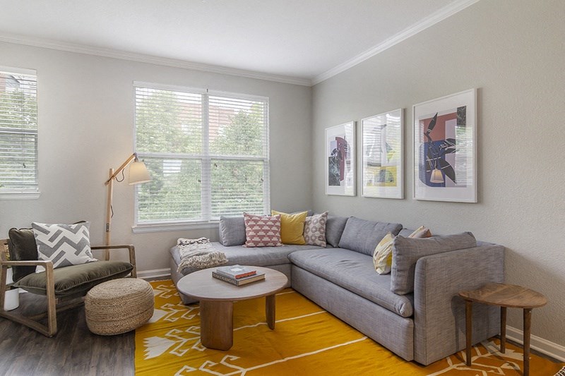 a living room with a couch and a chair and a table