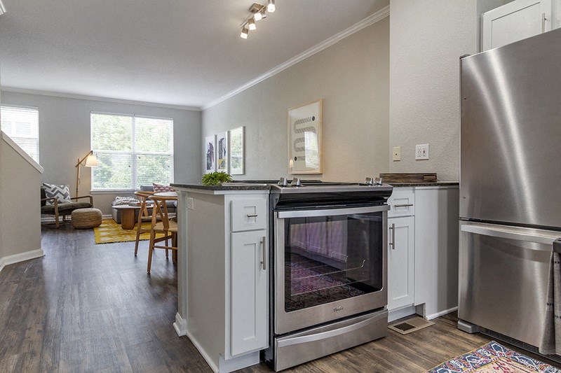 a kitchen with an oven and a stove and a refrigerator
