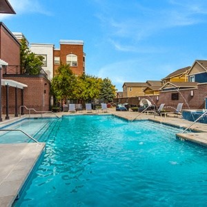 a large swimming pool with a building in the background