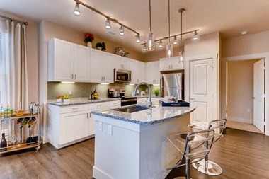 White cabinetry with light granite kitchen