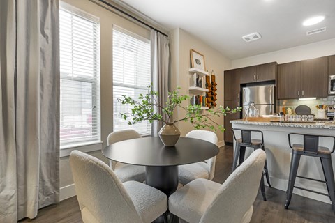 a dining room and kitchen with a table and chairs