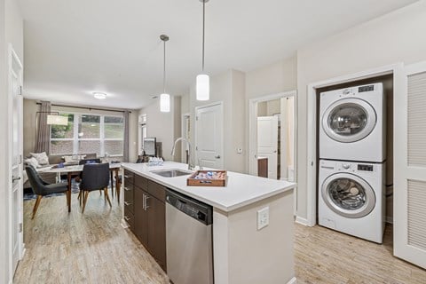 A modern kitchen with a dining table and chairs.