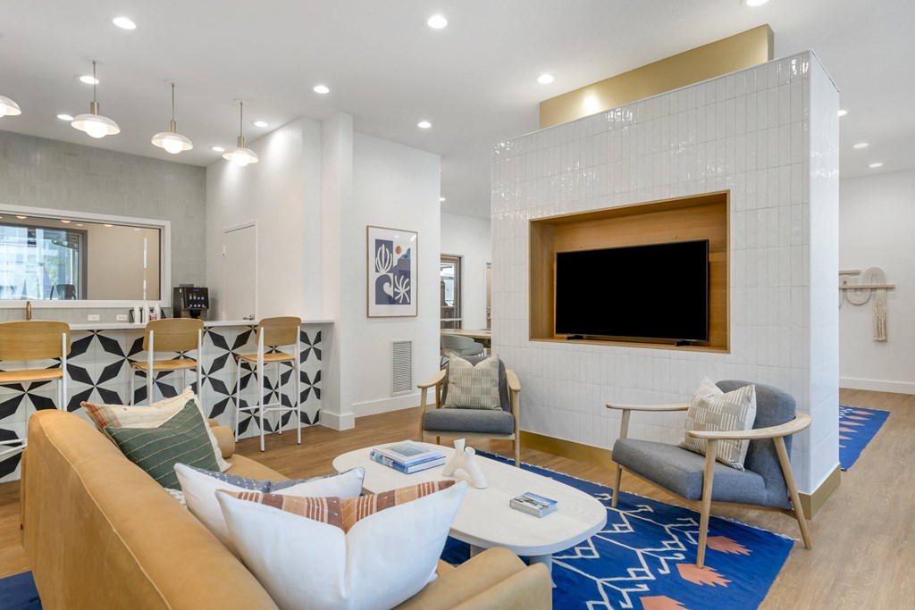 a living room with a couch and chairs and a television