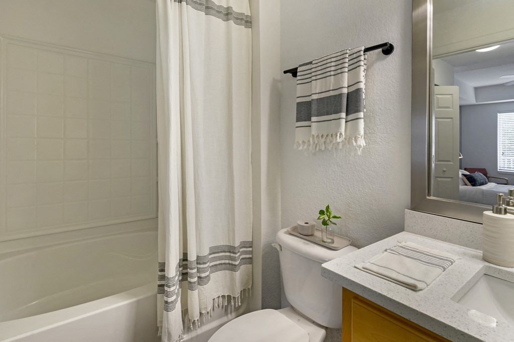 a bathroom with a shower and a toilet and a sink