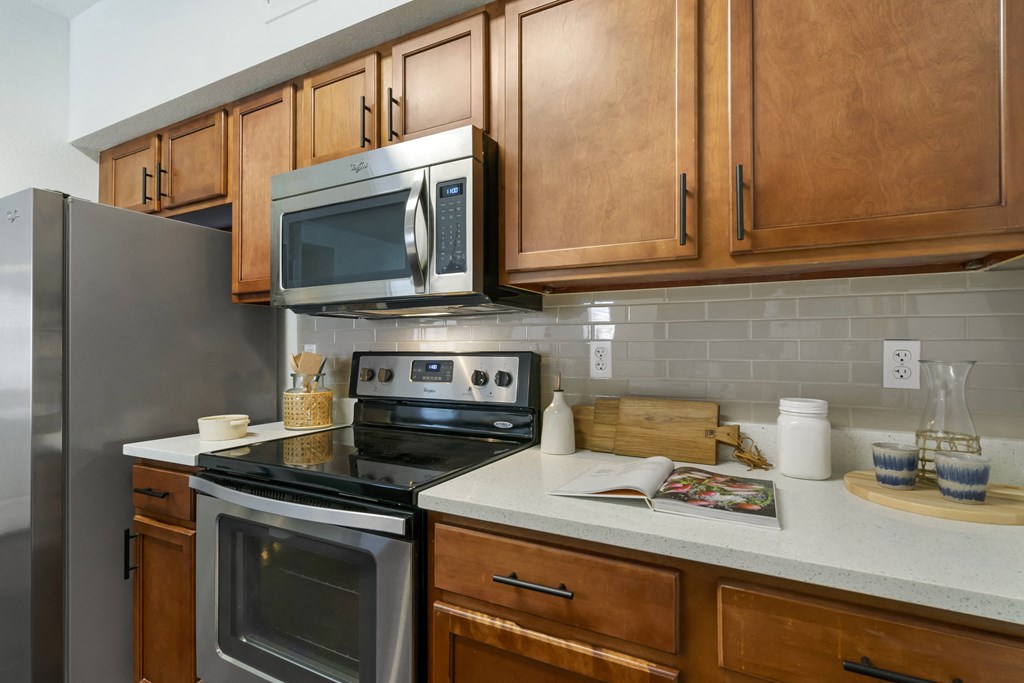 a kitchen with stainless steel appliances and wooden cabinets