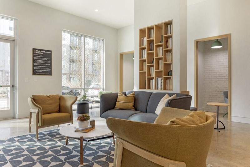 a living room with a couch chairs and a coffee table
