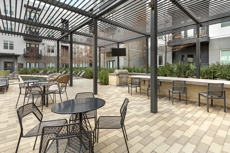 a patio with tables and chairs