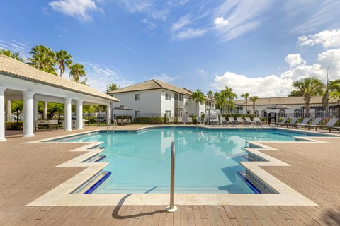 a pool with chairs surrounding it