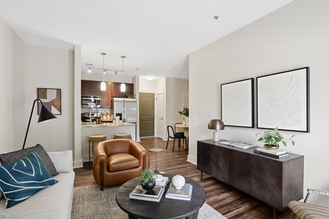 A living room with a brown leather chair and a white sofa.