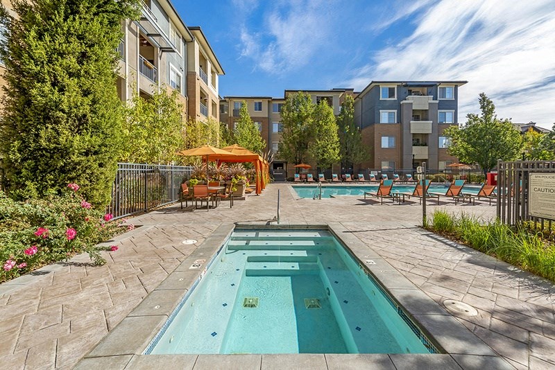 our apartments have a resort style pool with lounge chairs and tables