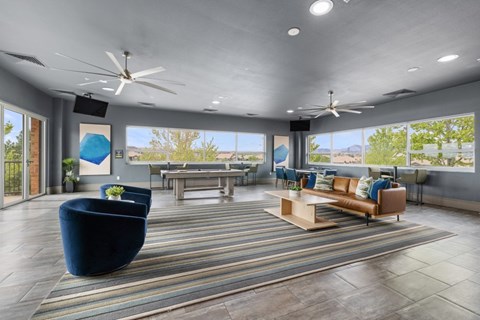 A spacious living room with a blue sofa and a wooden coffee table.