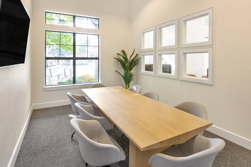 a conference room with a wooden table and chairs