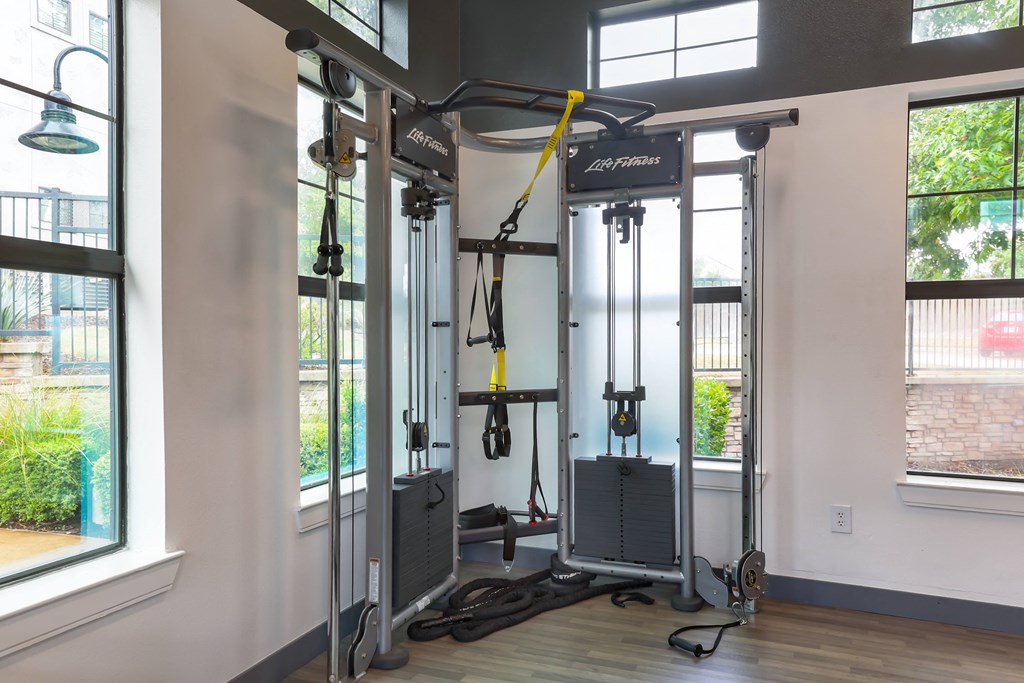 the evolution fitness room with weights machines and windows