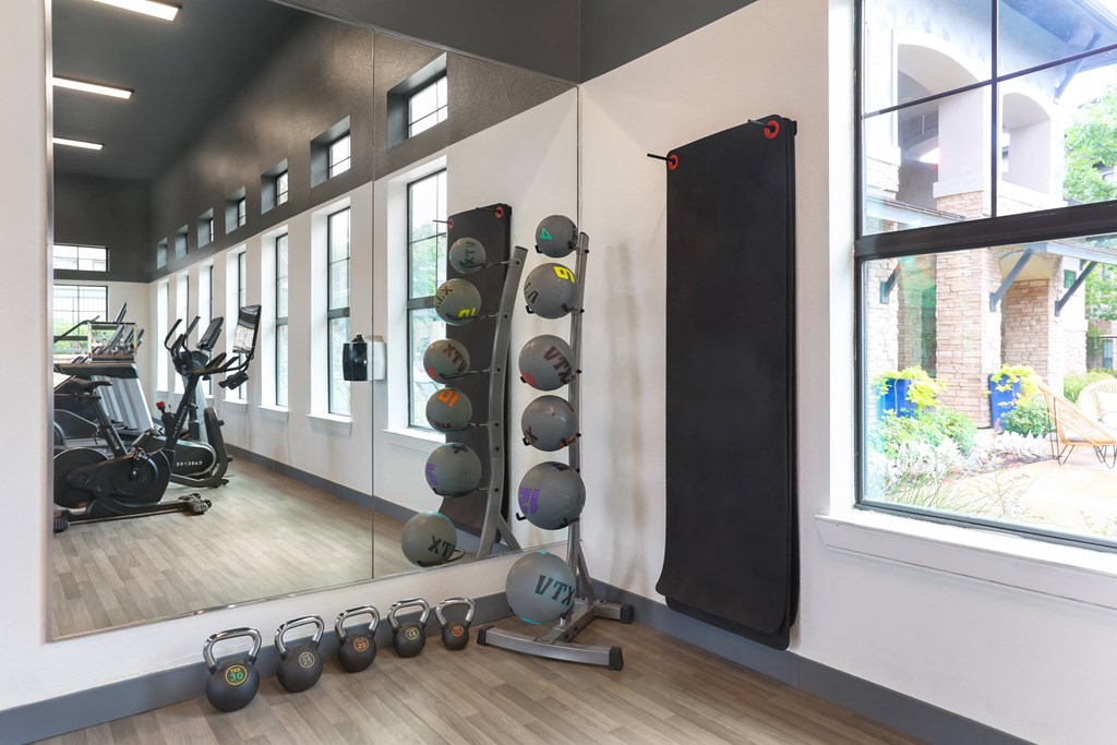 a gym with weights and a punching bag on the wall