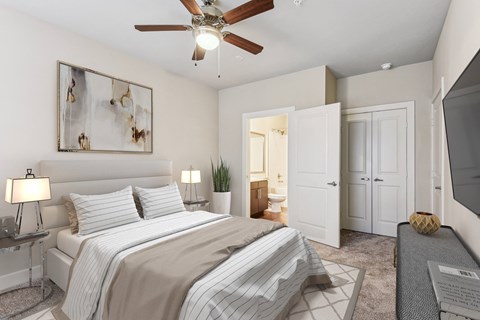 a bedroom with a large bed and a ceiling fan